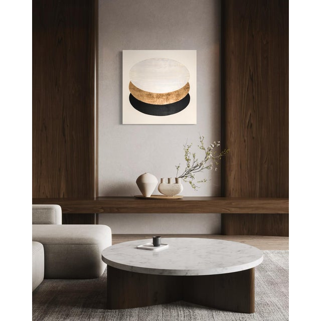A luminous, gold-leafed oval sits low against a stark black field, sliced cleanly by a pale horizontal band above it, day...