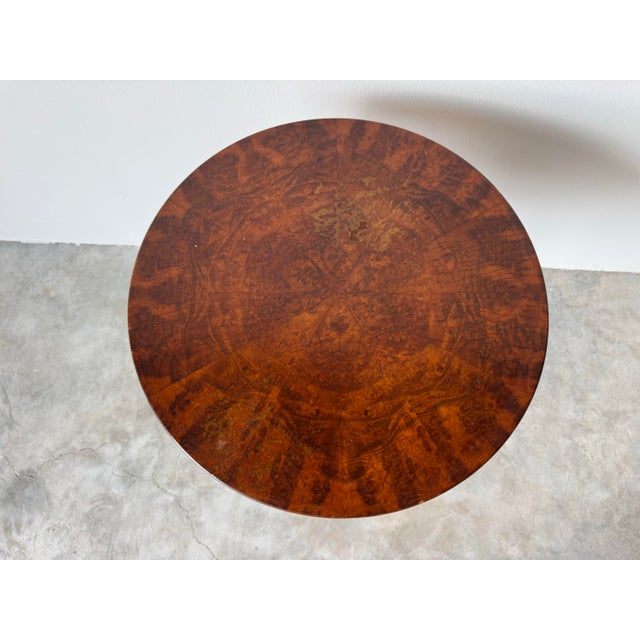 A striking 1980s vintage side table that blends classical regency charm with ornate craftsmanship. The circular top is...