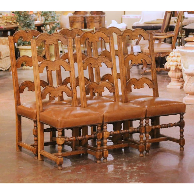 This set of six Louis XIII style dining chairs was crafted in southern France, circa 1970. Each chair is built of solid...