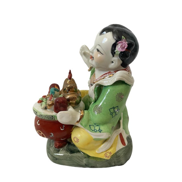 This vintage Famille Rose 8” Laughing Lucky Girl statue figurine is a beautiful representation of a Chinese lady offering...
