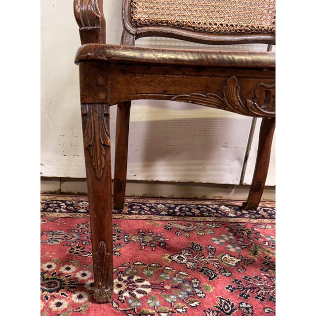 Louis XV period carved walnut office chair Cane seat and back Abundant carved decoration Violet-shaped Cabriole legs