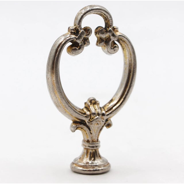 This finial features a fleur de lis design in cast brass. It provides a classic addition to your furniture, lighting, or...