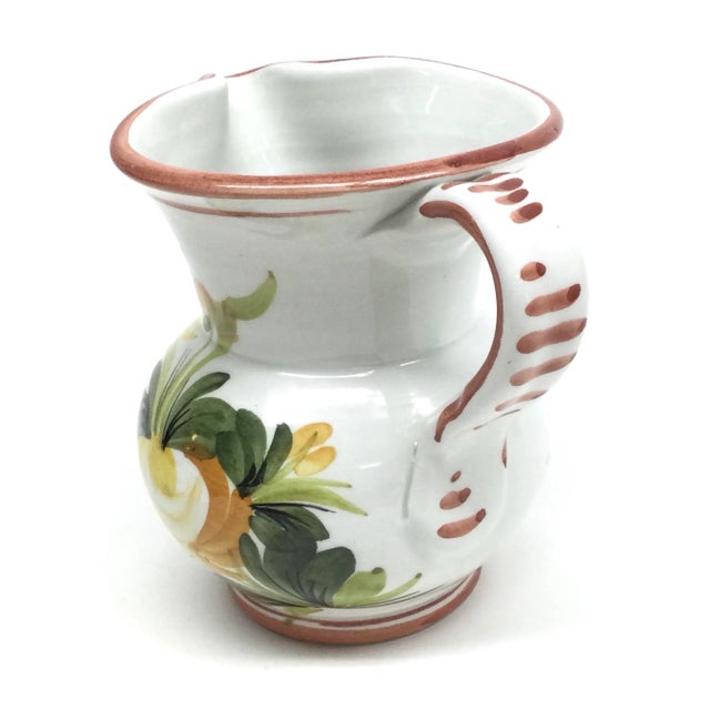 Very cool ceramic pitcher with hand painted flowers in yellow, orange, and lilac. Nice shape and no chips or repairs. In...