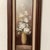 This vintage painting on driftwood titled “White Peony” by artist Robert Cox captures the essence of still life with its...