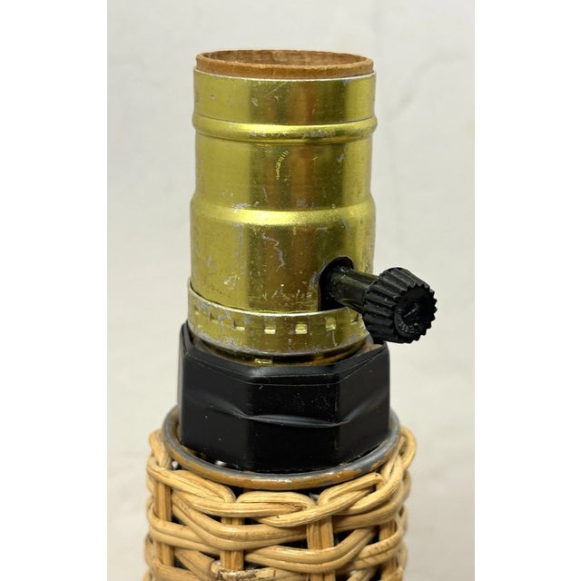 Add effortless mid-century style to your home with this vintage wicker table lamp. Featuring a handwoven rattan base and a...