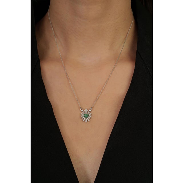 This pendant necklace featuring a 0.1 carat round cut emeralds set in 14K white gold. Each measuring approximately 1.3 mm....