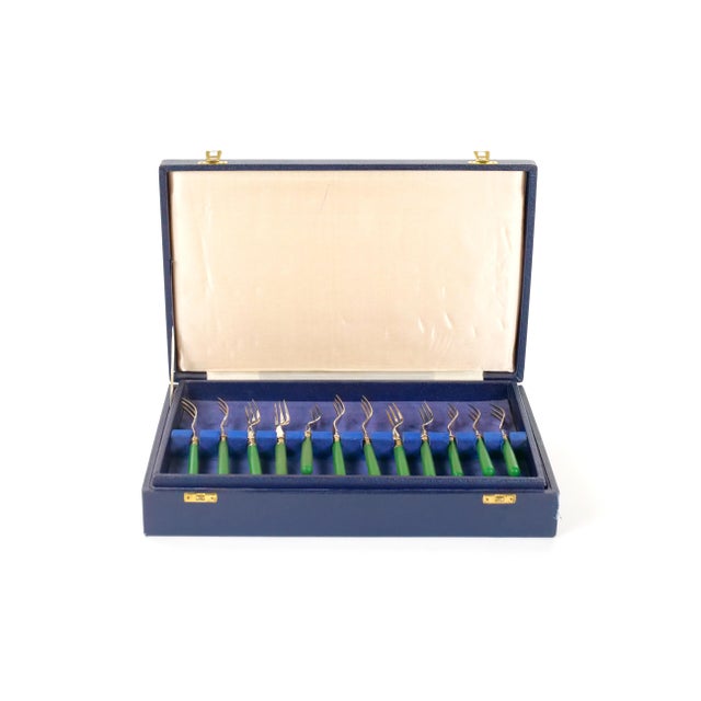 An elegant English fish cutlery service comprising 24 pieces, including 12 fish knives and 12 matching forks, crafted in...