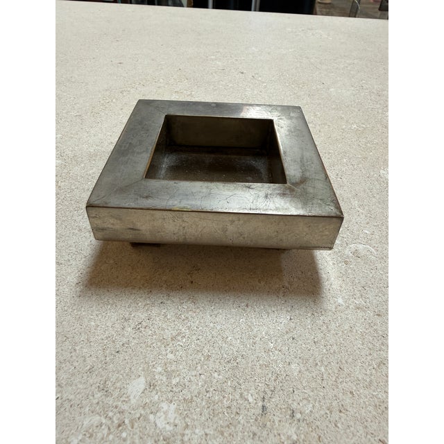 Minimalist vintage square catchall tray crafted from solid metal with a brushed finish and natural aged patina. The clean,...