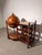 Decorative antique globe bar cart crafted in dark wood and richly decorated with detailed historical world maps. The large...