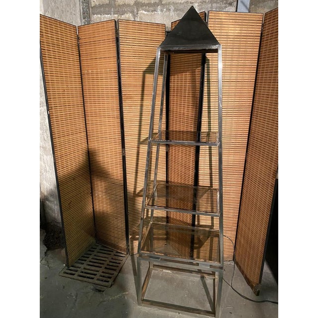 Illuminating shelf by designer Philippe Cheverny in a pyramidal shape from the 70s with smoked glass shelves. Publisher...