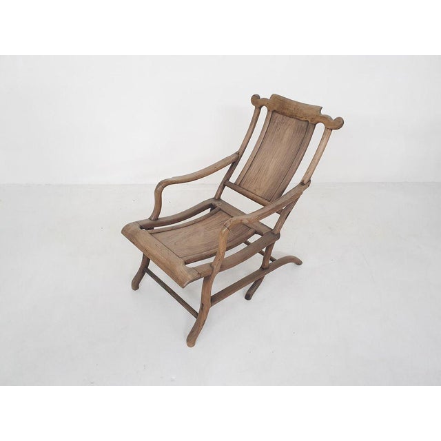 Sculptural solid wooden lounge chair. The lacquer has turned a bit white through the years, but this gives a nice patina...