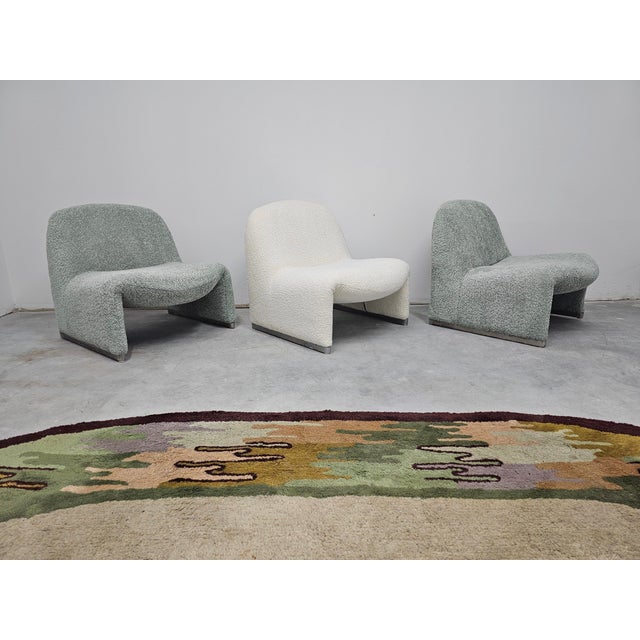 A pair of the Iconic Alky Chairs in pale green boucle, designed by Giancarlo Piretti for Artifort. This multifunctional...