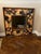 This vintage mirror with highly decorative frame serves as a piece of artwork. The painted or appliquéd border look like...