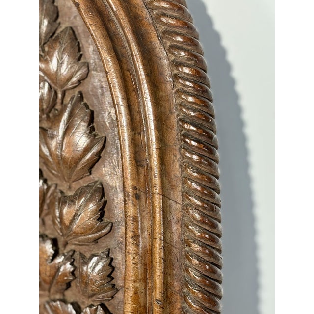 A set of three carved wooden panels, crafted from a single block of wood, depicting animal scenes. Each panel is carved...