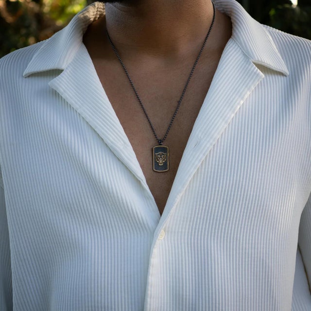 Embrace boldness and strength with the Powerful Lion Medallion Sterling Silver & Gold Chain Necklace. This striking piece...