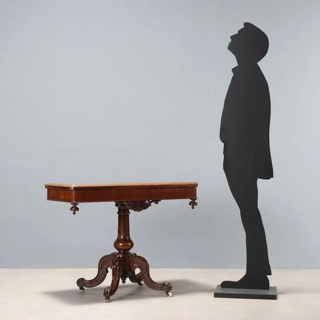 Louis Philippe mahogany game table. Revolving top concealing an open compartment that opens like a book, internal...