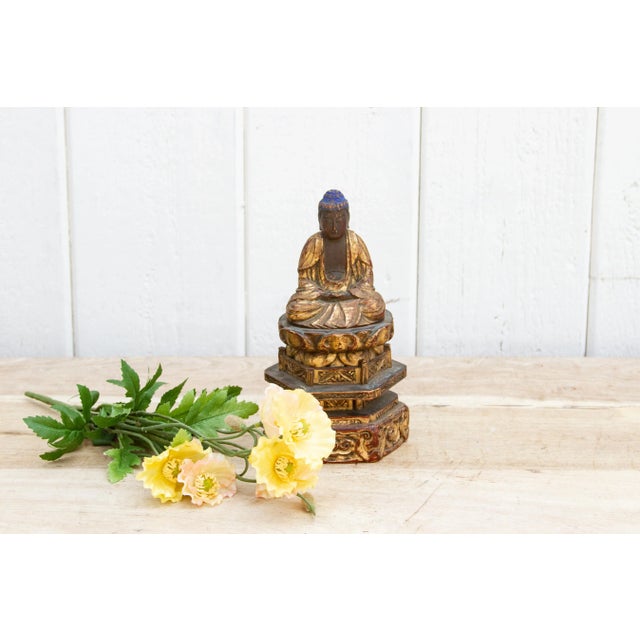 Small vintage Buddha hand-carved from wood. This intricately crafted sculpture showcases the Buddha in a seated position,...