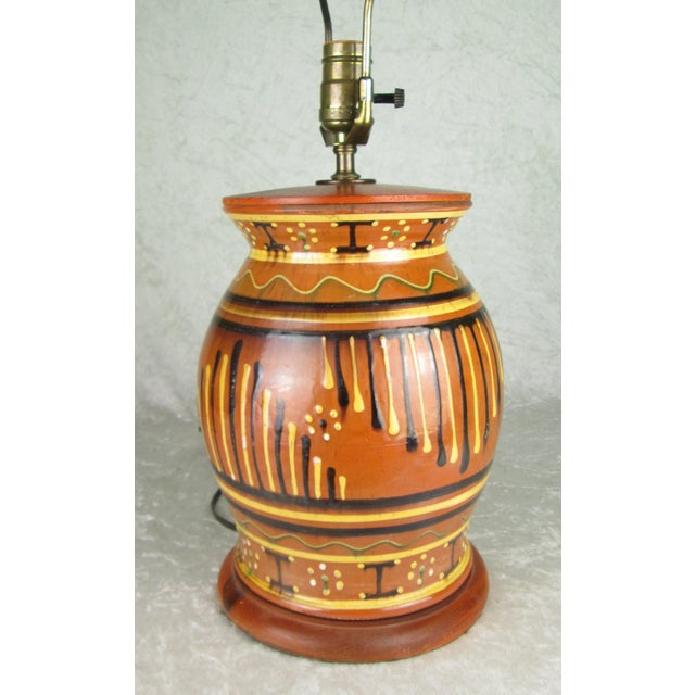 1994 Moravian redware pottery lamp by David T. Smith Turtle Creek Pottery in Morrow, Ohio. The lamp has geometric designs...