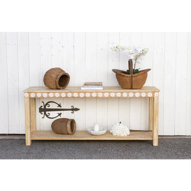 A charming console table with thick square legs and a lower shelf. Made from reclaimed teak, this large reconstructed...