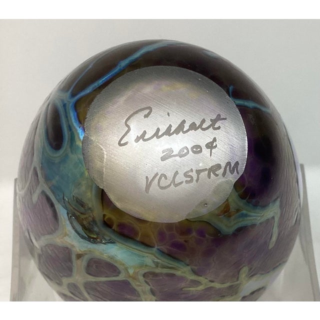 Hand-blown art glass vase by artist Robert Eickholt, American. Known for purple and blue lava-type coloration. 8” H x 4.5”...