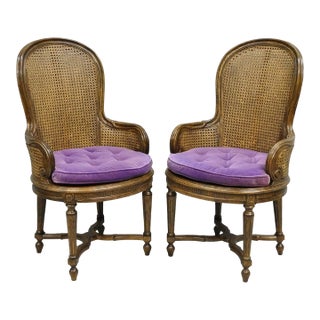 Mid 20th Century Vintage French Louis XVI Style Cane Balloon Back Walnut Arm Chairs - A Pair For Sale