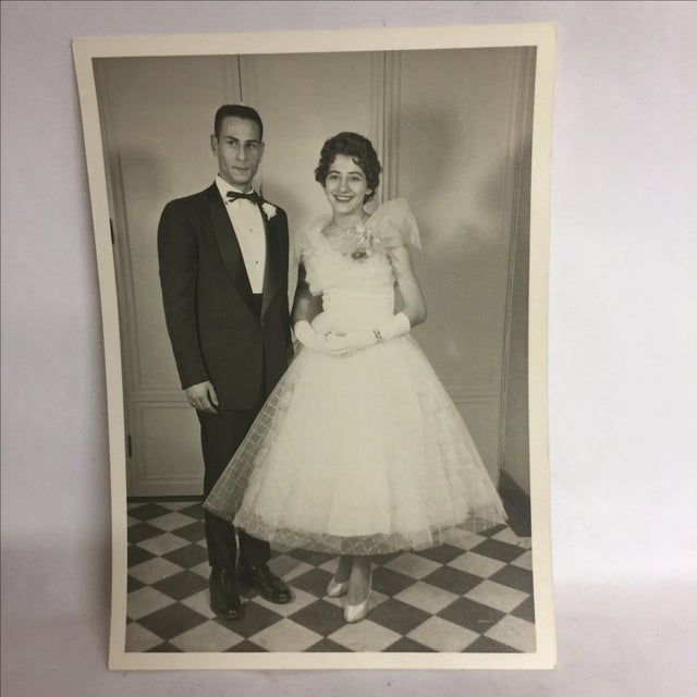 Nice black and white photo print of the happy couple on a checkerboard floor.
