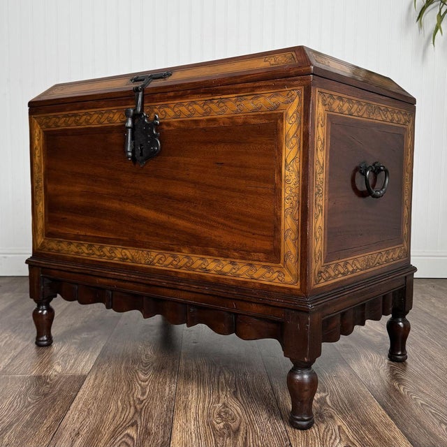 Rare and striking Spanish Colonial trunk by Alfonso Marina featuring an intricate engraved marquetry border, turned legs,...