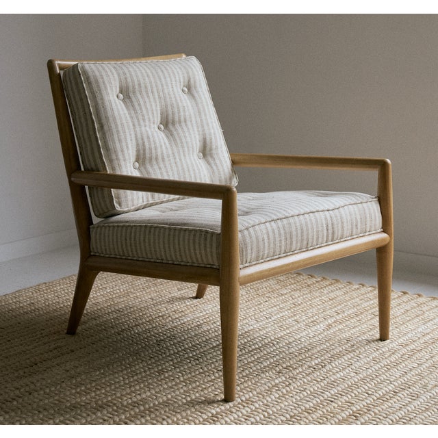 Pair of 1950s T.H. Robsjohn Gibbings armchairs, newly reupholstered in a striped linen fabric. These lounge chairs feature...