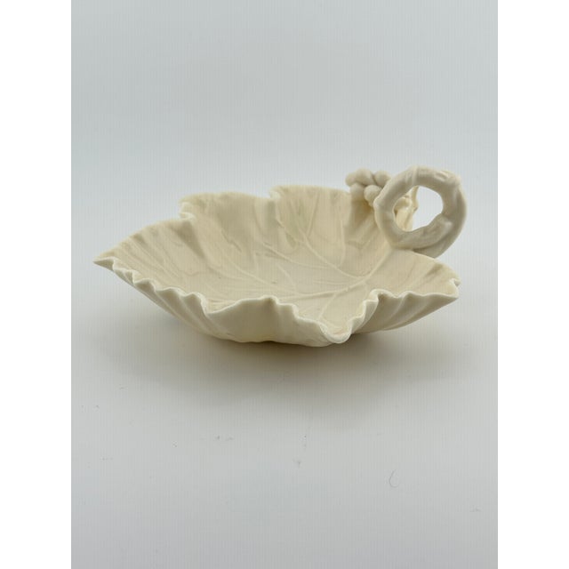 Vintage ivory ceramic catchall in the shape of a grape leaf. This is a pre-owned item so please see all pictures and ask...