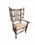 An English spindle back "wing" chair made of Ash with a rush seat, the back with two rows of five spindles with the arms...