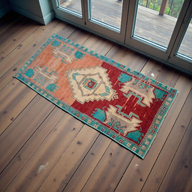 This vintage Oushak rug features a striking color-block transition from warm terracotta to deep madder red, grounded by a...