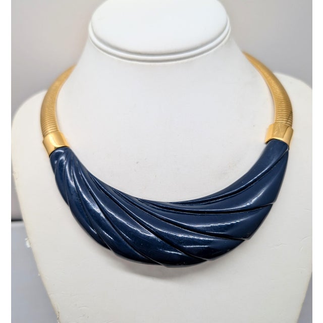 1980s goldtone molded navy blue resin center collar necklace with fold over clasp. Marked "©Monet" on the backside...