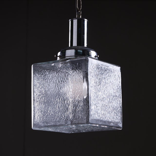 This beautiful pendant is shaped like a cuboid and made from dappled glass, giving it a unique and artistic appearance...