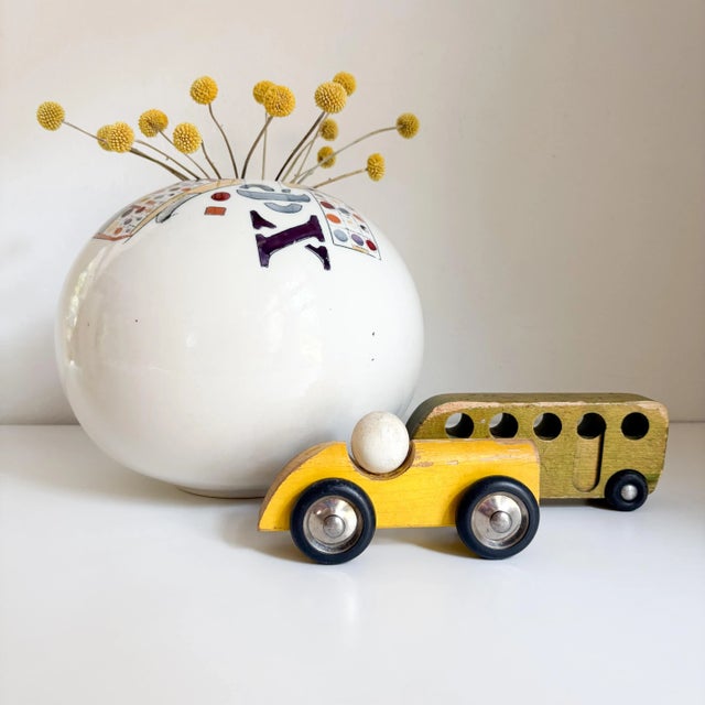 This signed 1980's postmodern orb shaped vase by Kirk Freeman is provocative, beautiful and striking. With it's muted...