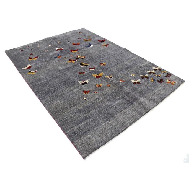 Gabbeh rugs are made by the nomadic Qashqai tribes of southern region. They are rough cut and long piled rugs of rich...