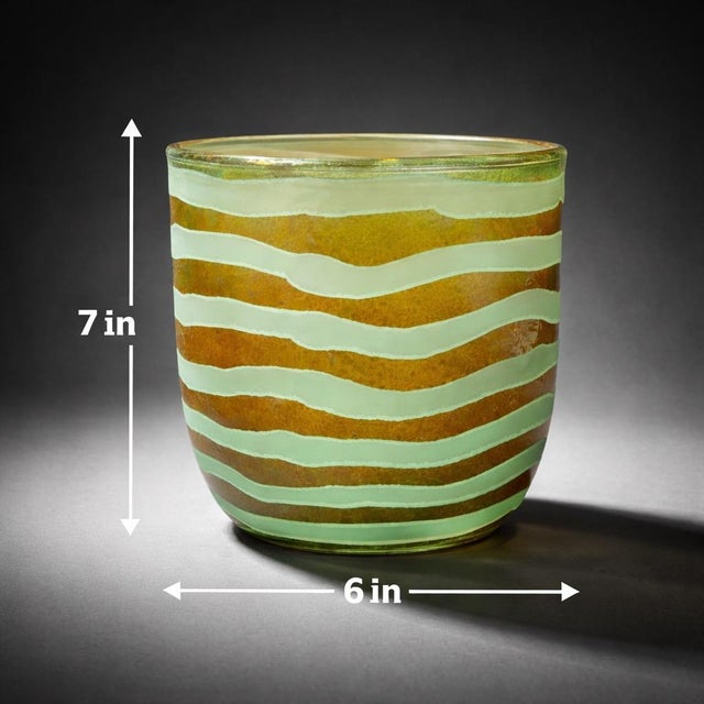 Mobile-Ready Description A striking hand-blown art glass vase featuring layered amber glass wrapped in flowing seafoam...
