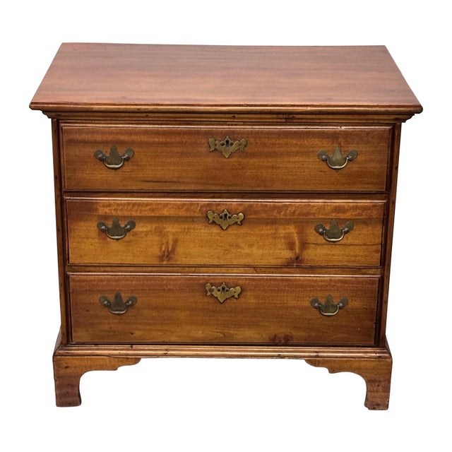 A small solid cherrywood three drawer chest with original brass hardware. In excellent refinished condition with faint...