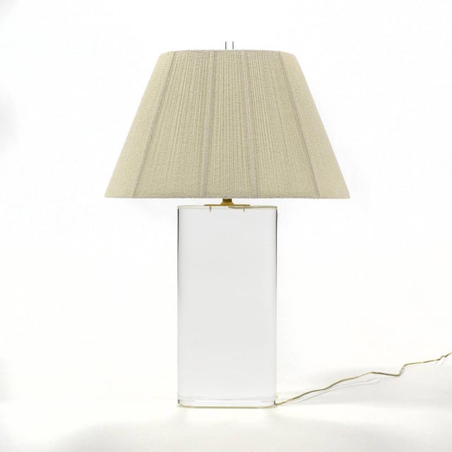 This spectacular table lamp has an oval base of 3" thick Lucite, the finest quality brass hardware, a perfectly matched...