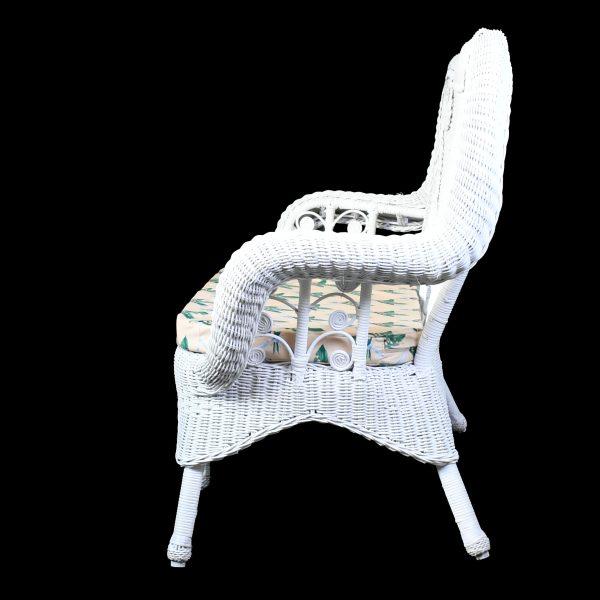 Add a touch of whimsy to your porch or sunroom with this charming white wicker settee. Its playful silhouette features...