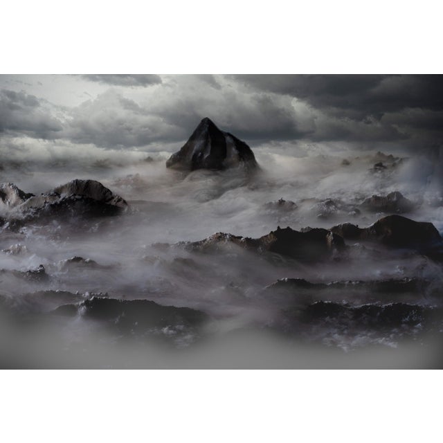 The artwork presents a dramatic seascape, where tumultuous waves crash against a stark, solitary rock formation under a...