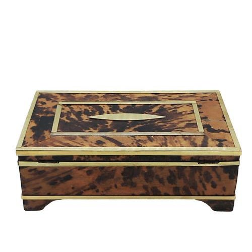 Large jewellery box in walnut root and brass, with brass borders and decorations, which opens to reveal small storage...