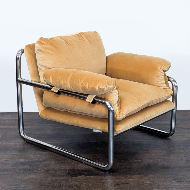 Add a cozy touch to your space with this West Elm lounge chair. It features a soft tan cushion and a sleek chrome frame....