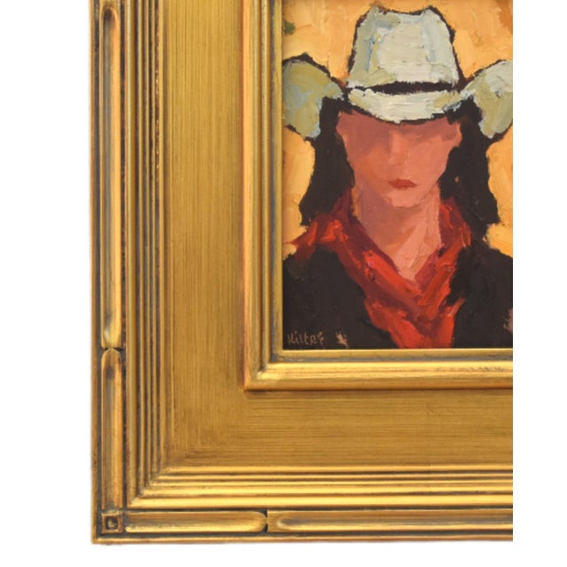 Impressionist oil painting on an artist's hardboard panel of a western cowgirl with a hat displayed in a complementary...