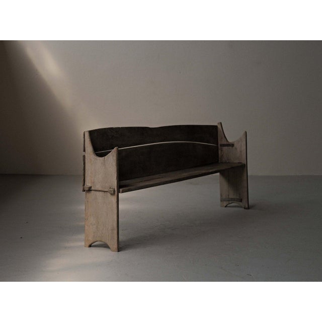 Long rustic bench, crafted from solid wood in 19th-century France, features a full backrest made of wide planks with a...