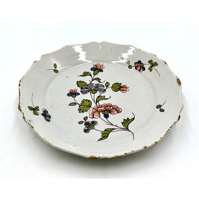 A gorgeous antique 18th-Century faience polychrome plate from the south-west region of France. This charming plate has...