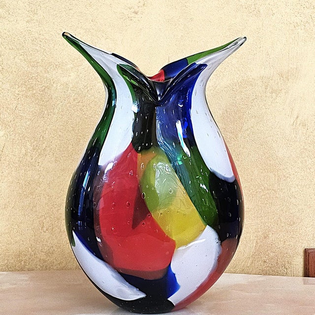 Vibrant Sculptural Studio Glass Centerpiece A stunning multicolored Murano‑style hand‑blown art glass vase featuring bold...