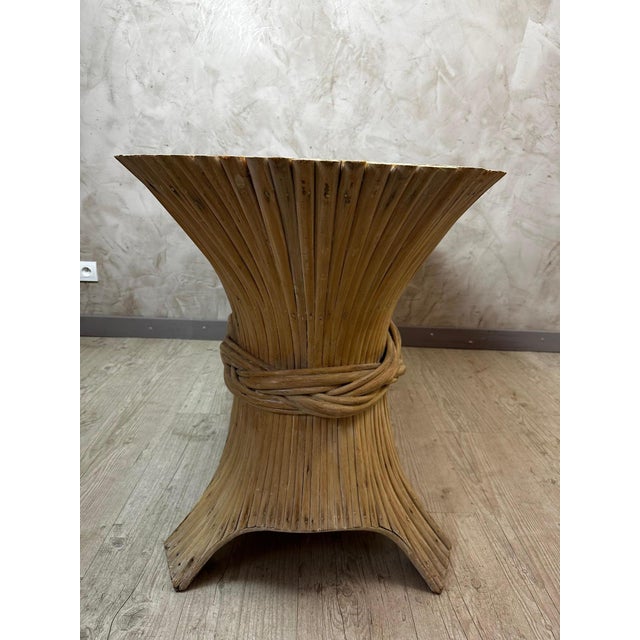 An elegant 1980s bamboo console table, attributed to designer Dorothy Macguire, emblematic of the revival of organic and...