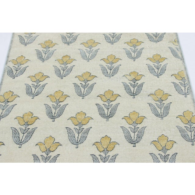 Hand-knotted in a luxurious blend of wool and silk, this 4x4 square rug is a radiant and sophisticated addition to the Rug...