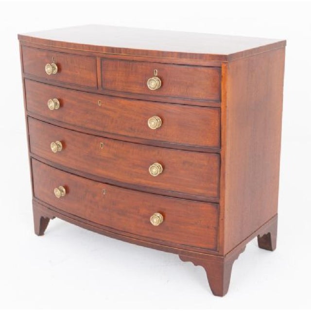A fine quality Regency mahogany bow-front chest of drawers, raised elegantly on splay feet. The piece features a classic...