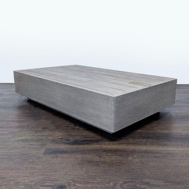 This modern coffee table features a clean rectangular design with a sleek weathered wood finish. Its low profile and...